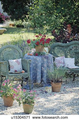 Stock Image - BLue chairs and blue cloth on table in country garden in summer. Fotosearch