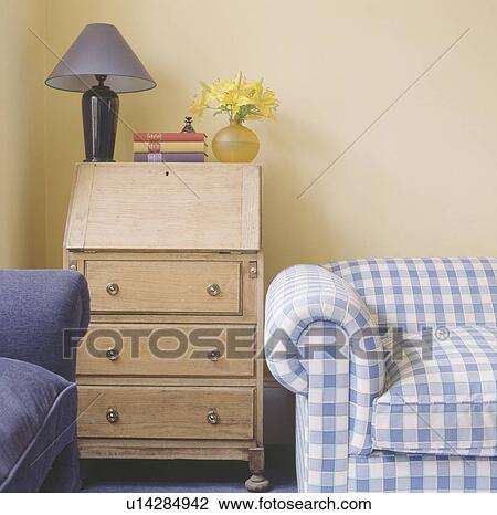 Blue lamp on small pine desk in corner of living room with blue & white checked sofa View Large Photo Image Stock Image - Blue lamp on small pine desk in corner of living room with blue & white checked sofa. Fotosearch