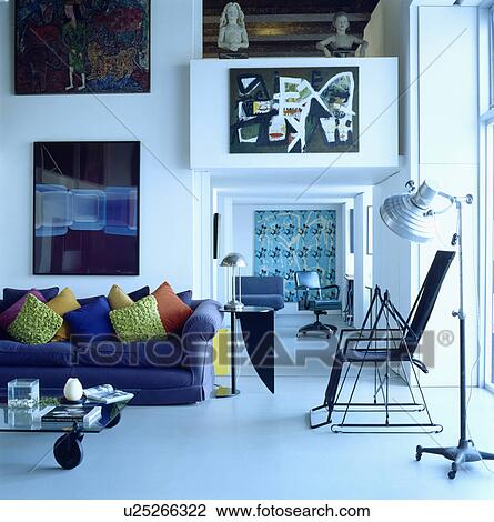 Stock Image - Blue sofa in modern living room with white flooring. Fotosearch