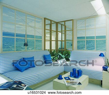 Blue striped sofas in iving room with seascape murals on walls View Large Photo Image Picture - Blue striped sofas in iving room with seascape murals on walls. Fotosearch