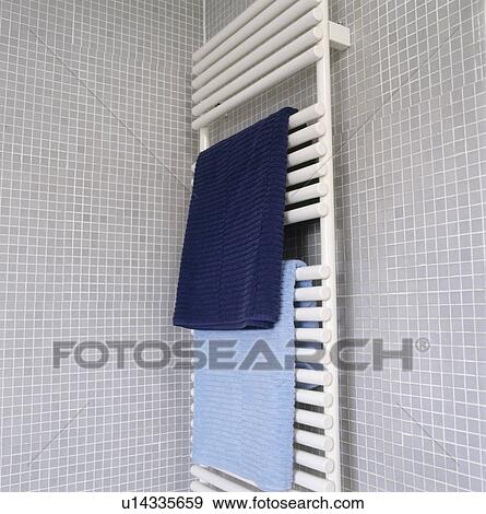 Blue towels on white heated towel rail on grey mosaic tiled bathroom wall View Large Photo Image Stock Photo - Blue towels on white heated towel rail on grey mosaic tiled bathroom wall. Fotosearch