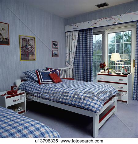 Blue+white checked duvets on twin beds in bedroom with blue wallpaper and white curtains with blue checked curtains View Large Photo Image Stock Photography - Blue+white checked duvets on twin beds in bedroom with blue wallpaper and white curtains with blue checked curtains. Fotosearch