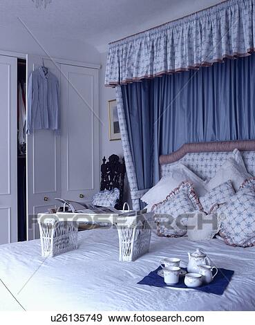 Blue+white drapes with blue lining on half-tester bed with breakfast tray and cane bookstand View Large Photo Image Stock Photo - Blue+white drapes with blue lining on half-tester bed with breakfast tray and cane bookstand. Fotosearch