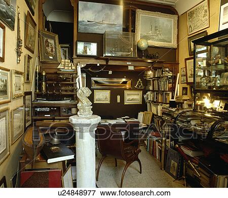 Stock Photo - Box room used as storage of paintings and other antiques.. Fotosearch