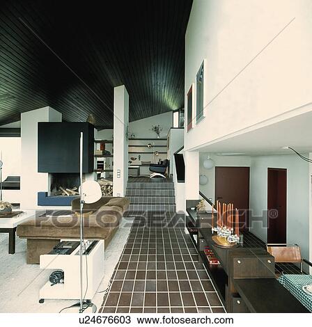 Brown floor tiles in eighties-style openplan living room View Large Photo Image Stock Image - Brown floor tiles in eighties-style openplan living room. Fotosearch
