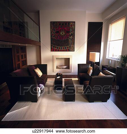 Picture - Brown leather sofas in modern black+white living room with white rug. Fotosearch