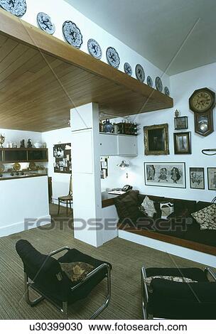 Stock Image - Brown sofa in sixties-style openplan living room. Fotosearch