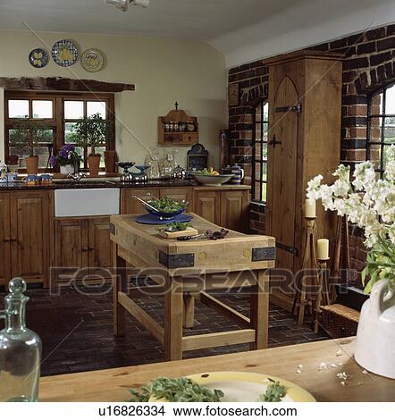 Picture - Butcher's block in centre of traditional country kitchen. Fotosearch