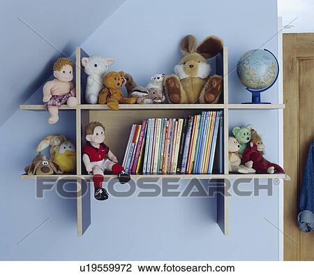 Children's books and toys on shelves in a blue attic bedroom View Large Photo Image Stock Image - Children's books and toys on shelves in a blue attic bedroom. Fotosearch