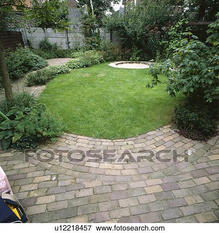 Circular lawn in brick paving in large town garden View Large Photo Image Stock Photo - Circular lawn in brick paving in large town garden. Fotosearch