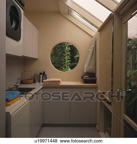 Circular window in modern utility room extension View Large Photo Image Stock Photo - Circular window in modern utility room extension. Fotosearch