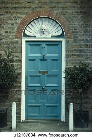 Classical plasterwork bust on fanlight above blue front door View Large Photo Image Picture - Classical plasterwork bust on fanlight above blue front door. Fotosearch