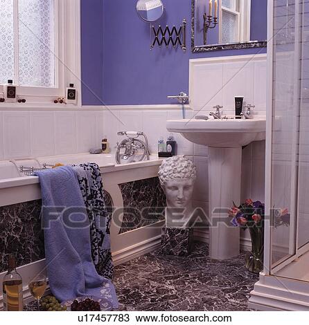 Classical sculpture head on marble-effect floor with matching bath panel in blue bathroom with white tiling View Large Photo Image Stock Image - Classical sculpture head on marble-effect floor with matching bath panel in blue bathroom with white tiling. Fotosearch