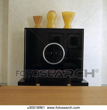 Close-up of amber vases on modern black cupboard View Large Photo Image Stock Image - Close-up of amber vases on modern black cupboard. Fotosearch