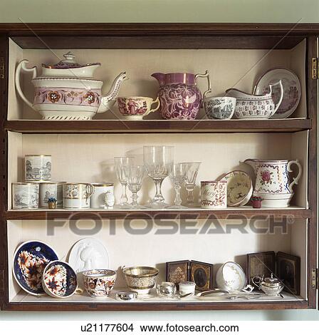 Close-up of antique jugs and teapot with cups and glasses on shelves View Large Photo Image Picture - Close-up of antique jugs and teapot with cups and glasses on shelves. Fotosearch
