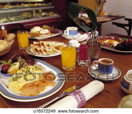 Close up of bacon+egg breakfast with fruit juice and toast and cups of coffee View Large Photo Image Stock Photo - Close up of bacon+egg breakfast with fruit juice and toast and cups of coffee. Fotosearch