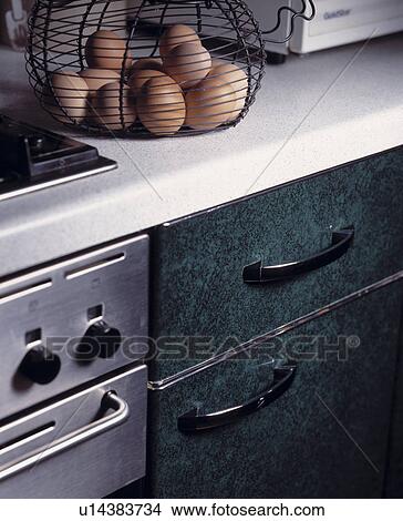 Picture - Close-up of basket of eggs on worktop above dishwasher. Fotosearch