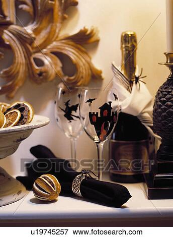 Close up of black napkin and wineglasses decorated with Halloween motifs beside pomander and champagne bottle View Large Photo Image Stock Photo - Close up of black napkin and wineglasses decorated with Halloween motifs beside pomander and champagne bottle. Fotosearch