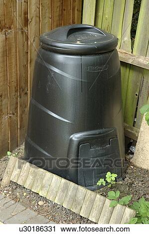 Stock Image - Close-up of black plastic compost bin. Fotosearch