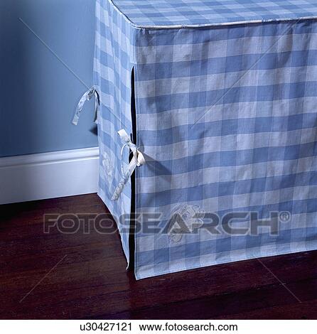 Stock Image - Close-up of blue and white check cotton storage box. Fotosearch