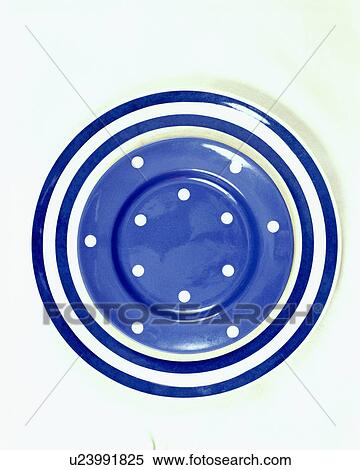 Stock Photography - Close-up of blue and white striped and spotted plate. Fotosearch