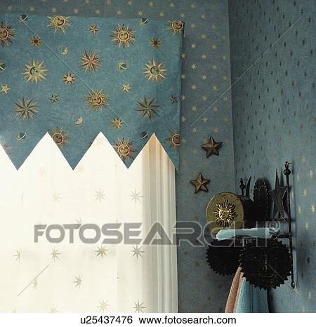 Stock Photograph - Close-up of blue pelmet with gold celestial motif. Fotosearch
