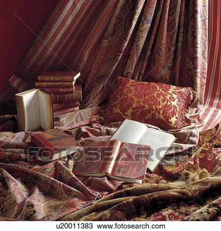 Close-up of books and red patterned cushion and curtains View Large Photo Image Stock Image - Close-up of books and red patterned cushion and curtains. Fotosearch