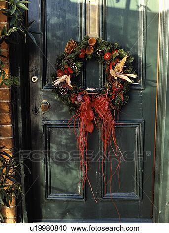 Close-up of Christmas wreath on front door View Large Photo Image Stock Image - Close-up of Christmas wreath on front door. Fotosearch