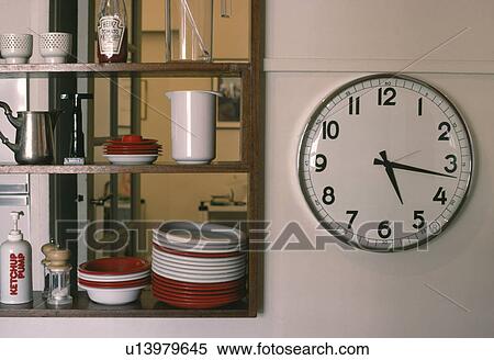 Close-up of circular clock on wall beside shelves View Large Photo Image Stock Photography - Close-up of circular clock on wall beside shelves. Fotosearch