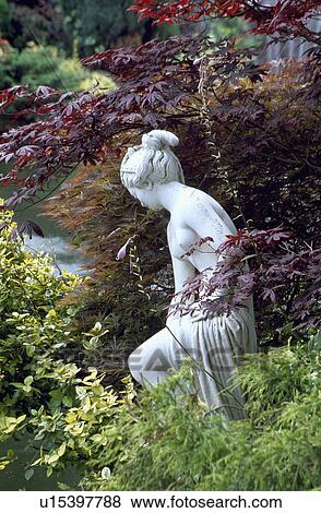 Stock Photo - Close-up of classical statues in the garden. Fotosearch