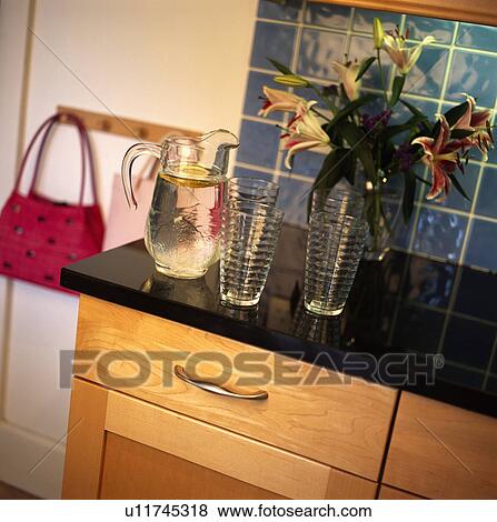 Close-up of clear glass jug and glasses on granite worktop View Large Photo Image Stock Photo - Close-up of clear glass jug and glasses on granite worktop. Fotosearch