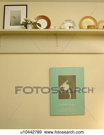 Close-up of crockery on shelf above small black and white photograph in pastel green frame View Large Photo Image Stock Photo - Close-up of crockery on shelf above small black and white photograph in pastel green frame. Fotosearch