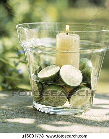Stock Photo - Close-Up of Cut Limes and a Candle.. Fotosearch
