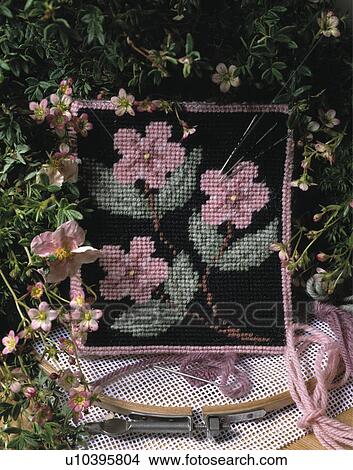 Picture - Close-up of floral cross stitch cushion. Fotosearch