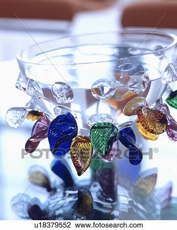 Close-up of glass bowl decorated with brightly coloured glass leaves View Large Photo Image Stock Image - Close-up of glass bowl decorated with brightly coloured glass leaves. Fotosearch