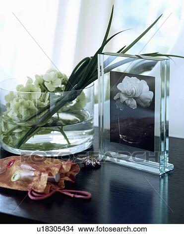 Picture - Close-up of glass photograph frame and flowers in glass bowl. Fotosearch