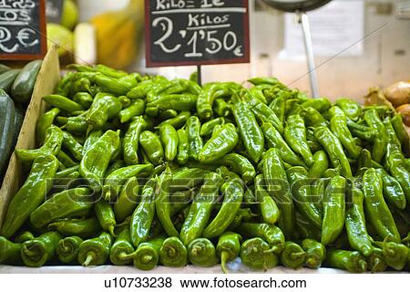 Close up of green chillies on Spanish market stall View Large Photo Image Stock Photo - Close up of green chillies on Spanish market stall. Fotosearch