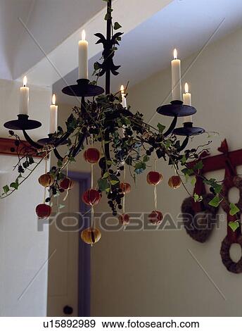 Close-up of lighted chandelier with Christmas decorations View Large Photo Image Stock Photo - Close-up of lighted chandelier with Christmas decorations. Fotosearch