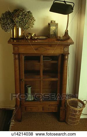 Stock Photo - Close-up of lighted thirties lamp on antique cupboard. Fotosearch
