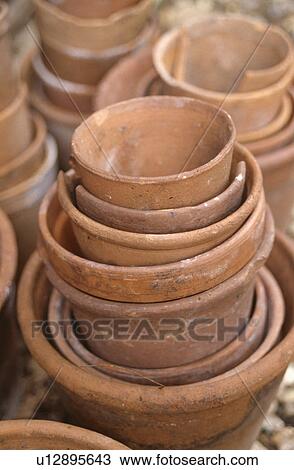 Close-up of old terracotta pots of varying sizes View Large Photo Image Stock Image - Close-up of old terracotta pots of varying sizes. Fotosearch