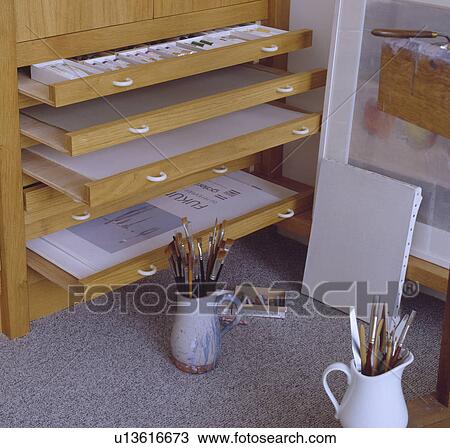 Stock Image - Close-up of open drawers of plans chest. Fotosearch