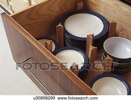 Close-up of open storage drawer with plates and bowls View Large Photo Image Stock Photo - Close-up of open storage drawer with plates and bowls. Fotosearch