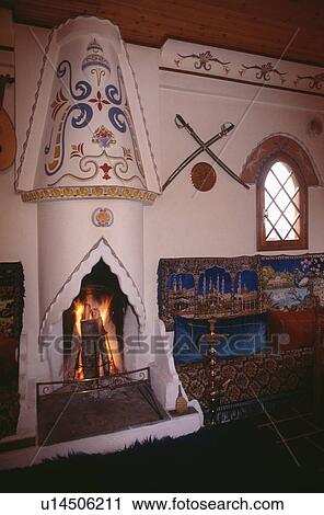 Stock Image - Close-up of painted ethnic fireplace. Fotosearch