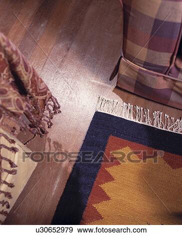 Close-up of patterned rug on wooden floor View Large Photo Image Stock Photo - Close-up of patterned rug on wooden floor. Fotosearch