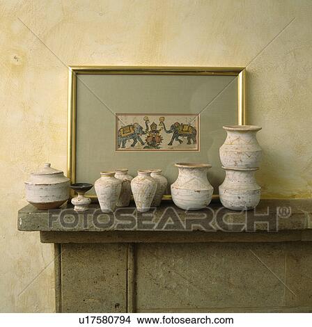Close-up of picture and collection of small ethnic pots and amphora on stone mantelpiece View Large Photo Image Picture - Close-up of picture and collection of small ethnic pots and amphora on stone mantelpiece. Fotosearch