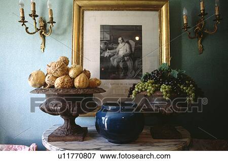 Stock Photo - Close-up of picture and gourds in vase on table. Fotosearch