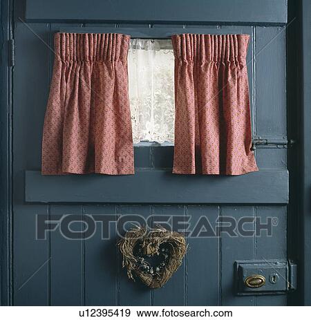 Close Up Of Pink Curtains And White Lace Curtain At Small Window