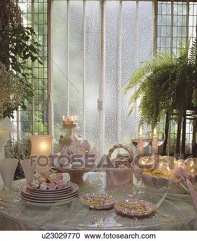Close up of pink+white sweets and candles on table with houseplants in the background View Large Photo Image Stock Image - Close up of pink+white sweets and candles on table with houseplants in the background. Fotosearch