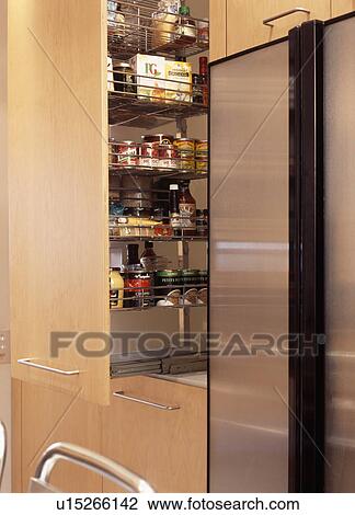 Close-up of pull-out shelves beside large freestanding stainless steel fridge-freezer View Large Photo Image Stock Image - Close-up of pull-out shelves beside large freestanding stainless steel fridge-freezer. Fotosearch