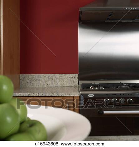 Close-up of range oven with stainless steel splashback View Large Photo Image Stock Photo - Close-up of range oven with stainless steel splashback. Fotosearch